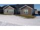 Rear view of house with snow-covered yard at 173 Megan Way, Cumberland, IN 46229