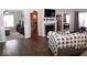 Open living room with hardwood floors, fireplace, and views to other rooms at 173 Megan Way, Cumberland, IN 46229