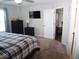 Main bedroom with king bed, TV, and access to other rooms at 173 Megan Way, Cumberland, IN 46229