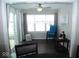Sunroom boasts hardwood floors, ceiling fan, and multiple windows offering natural light at 173 Megan Way, Cumberland, IN 46229