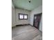 Dining room with new floors and walls needing work at 1826 Tallman Ave, Indianapolis, IN 46218