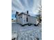 White sided home with a snow covered yard at 1826 Tallman Ave, Indianapolis, IN 46218