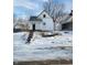 White house with front porch and snowy yard at 1826 Tallman Ave, Indianapolis, IN 46218