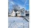 White house with front porch, steps, and snowy yard at 1826 Tallman Ave, Indianapolis, IN 46218