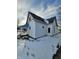 Rear view of a white house with snowy yard at 1826 Tallman Ave, Indianapolis, IN 46218