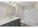 Bathroom featuring gray vanity, light countertop, tub/shower combo, vinyl flooring, and updated fixtures at 1833 Luther St, Indianapolis, IN 46203