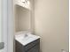 Neutral powder room features a modern vanity, sink, and mirror, offering a simple yet stylish design at 1833 Luther St, Indianapolis, IN 46203