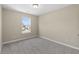Bedroom with neutral walls, carpet, white trim, and a window overlooking a neighborhood at 1833 Luther St, Indianapolis, IN 46203