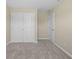 This bedroom features neutral walls, neutral carpet, a double door closet, and white trim at 1833 Luther St, Indianapolis, IN 46203