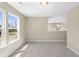 Neutral bonus room features large windows providing ample natural light, carpet flooring, and an open layout at 1833 Luther St, Indianapolis, IN 46203