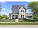 Two-story home with gray siding, a dark roof, a covered front porch, and manicured landscaping at 1833 Luther St, Indianapolis, IN 46203