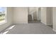 Bright, carpeted living room adjacent to staircase and hardwood flooring leading to interior door at 1833 Luther St, Indianapolis, IN 46203