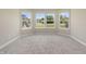Sitting area or reading nook with large windows that fill the space with natural light and a carpeted floor at 1833 Luther St, Indianapolis, IN 46203