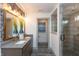 Bathroom featuring dual sinks, an oversized mirror, and a glass-enclosed shower at 1837 Luther St, Indianapolis, IN 46203