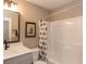 Simple bathroom with a bathtub/shower combination, a black and white shower curtain, and a vanity with a mirror at 1837 Luther St, Indianapolis, IN 46203