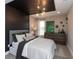 Stylish bedroom with a black accent wall, modern lighting, and a large dresser at 1837 Luther St, Indianapolis, IN 46203