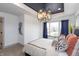 Bright bedroom features a tray ceiling, modern chandelier, and large windows for plenty of natural light at 1837 Luther St, Indianapolis, IN 46203