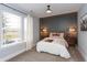 Cozy bedroom with a large window, hardwood floors, and a neutral color palette at 1837 Luther St, Indianapolis, IN 46203