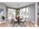 Bright dining room with modern lighting, neutral walls, and a view of the backyard at 1837 Luther St, Indianapolis, IN 46203