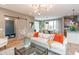 Bright living room features hardwood floors, a modern light fixture, and open access to the kitchen and dining room at 1837 Luther St, Indianapolis, IN 46203