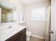 Well-lit bathroom features a vanity with dark cabinets, a toilet, and a shower with curtain at 1841 Luther St, Indianapolis, IN 46203