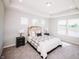 Bright main bedroom features a king bed, carpeted floors, and ample natural light from multiple windows at 1841 Luther St, Indianapolis, IN 46203
