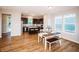 Bright dining room with wood floors adjacent to open kitchen and large windows at 1841 Luther St, Indianapolis, IN 46203