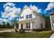 Inviting two-story home with a manicured lawn and young tree, offering a glimpse of comfortable suburban living at 1841 Luther St, Indianapolis, IN 46203