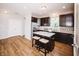 An open kitchen with an island, stainless steel appliances, and a view to a door at 1841 Luther St, Indianapolis, IN 46203
