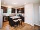 Kitchen features an island with seating, stainless steel appliances, and dark wood cabinetry at 1841 Luther St, Indianapolis, IN 46203