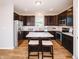 Spacious kitchen includes stainless steel appliances and dark wood cabinets at 1841 Luther St, Indianapolis, IN 46203