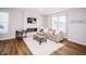 Comfortable living room featuring a stylish sofa, decorative fireplace, and inviting natural light from nearby windows at 1841 Luther St, Indianapolis, IN 46203