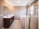 Modern bathroom with dual sinks, vanity, and a glass-enclosed shower at 1902 Zwingley St, Indianapolis, IN 46203