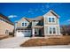 Charming two-story home with a two car garage and a well-lit porch at 1902 Zwingley St, Indianapolis, IN 46203