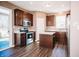 Modern kitchen with dark cabinetry, stainless steel appliances, and an island with a marble top at 1902 Zwingley St, Indianapolis, IN 46203