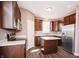 Modern kitchen with dark cabinetry, stainless steel appliances, and an island with a marble top at 1902 Zwingley St, Indianapolis, IN 46203