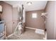 The utility room has tile floors, a water heater, an HVAC system, and a small window for natural light at 1902 Zwingley St, Indianapolis, IN 46203