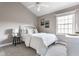 Cozy bedroom with neutral colors, soft natural light and white wood furnishings at 2010 Rhettsbury St, Carmel, IN 46032