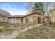 Charming single-story home with wood shingles, inviting front entrance, and an outdoor seating area at 2230 E 75Th St, Indianapolis, IN 46240