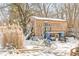 Small wooden outbuilding with various items stored outside at 2230 E 75Th St, Indianapolis, IN 46240