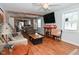 Spacious living room with hardwood floors and large TV at 2515 Fairfax Rd, Indianapolis, IN 46227