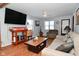 Spacious living room with hardwood floors and large TV at 2515 Fairfax Rd, Indianapolis, IN 46227