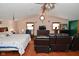 Main bedroom with sitting area, wood floors, and a king-size bed at 2515 Fairfax Rd, Indianapolis, IN 46227