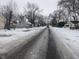 Residential street scene in winter with houses and snow-covered yards at 3050 N Gladstone Ave, Indianapolis, IN 46218