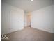 A carpeted bedroom features a double door closet and doorway to another room at 3201 W Keepsake Ln, Monrovia, IN 46157