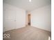 Bright and empty bedroom with neutral carpet and a door to another room at 3201 W Keepsake Ln, Monrovia, IN 46157