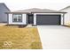 Charming home with a modern exterior, black accents, and a well-maintained lawn and driveway at 3201 W Keepsake Ln, Monrovia, IN 46157