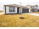 Attractive home featuring a white facade, black trim, and a well-manicured lawn and driveway at 3201 W Keepsake Ln, Monrovia, IN 46157