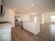 View of the open-concept kitchen, featuring modern appliances and wood-look flooring at 3201 W Keepsake Ln, Monrovia, IN 46157