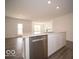 Bright kitchen features stainless dishwasher, island, and stone countertops at 3201 W Keepsake Ln, Monrovia, IN 46157